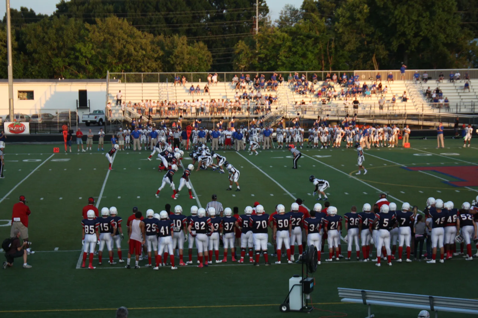 Lafayette and Lexington Catholic line up on the field in front of the home stands during their game in Lexington
