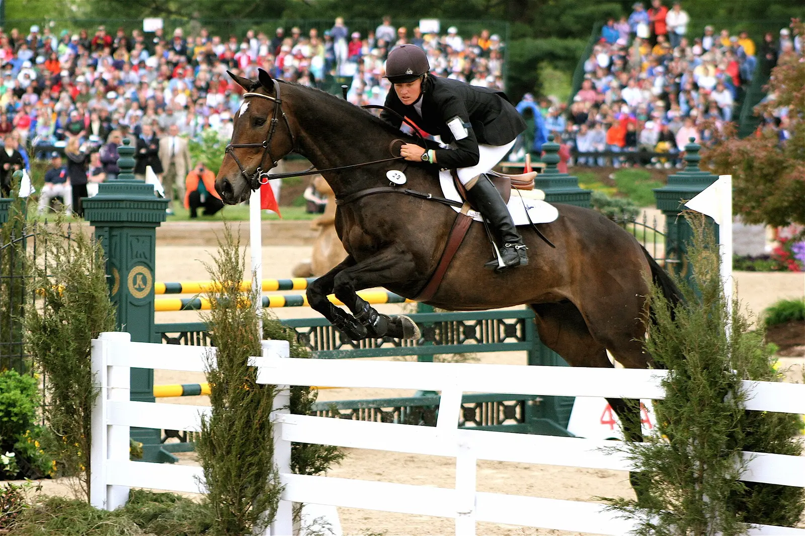 A rider and horse clear a fence in the show jumping phase of the Kentucky Three-Day Event at the Kentucky Horse Park in Lexington