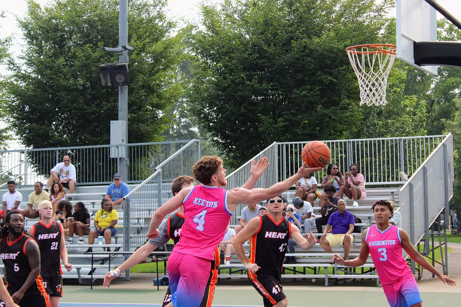 A player shoots during the Lexington Dirt Bowl basketball tournament at Douglass Park, home of one of the city pools that stays open through Labor Day