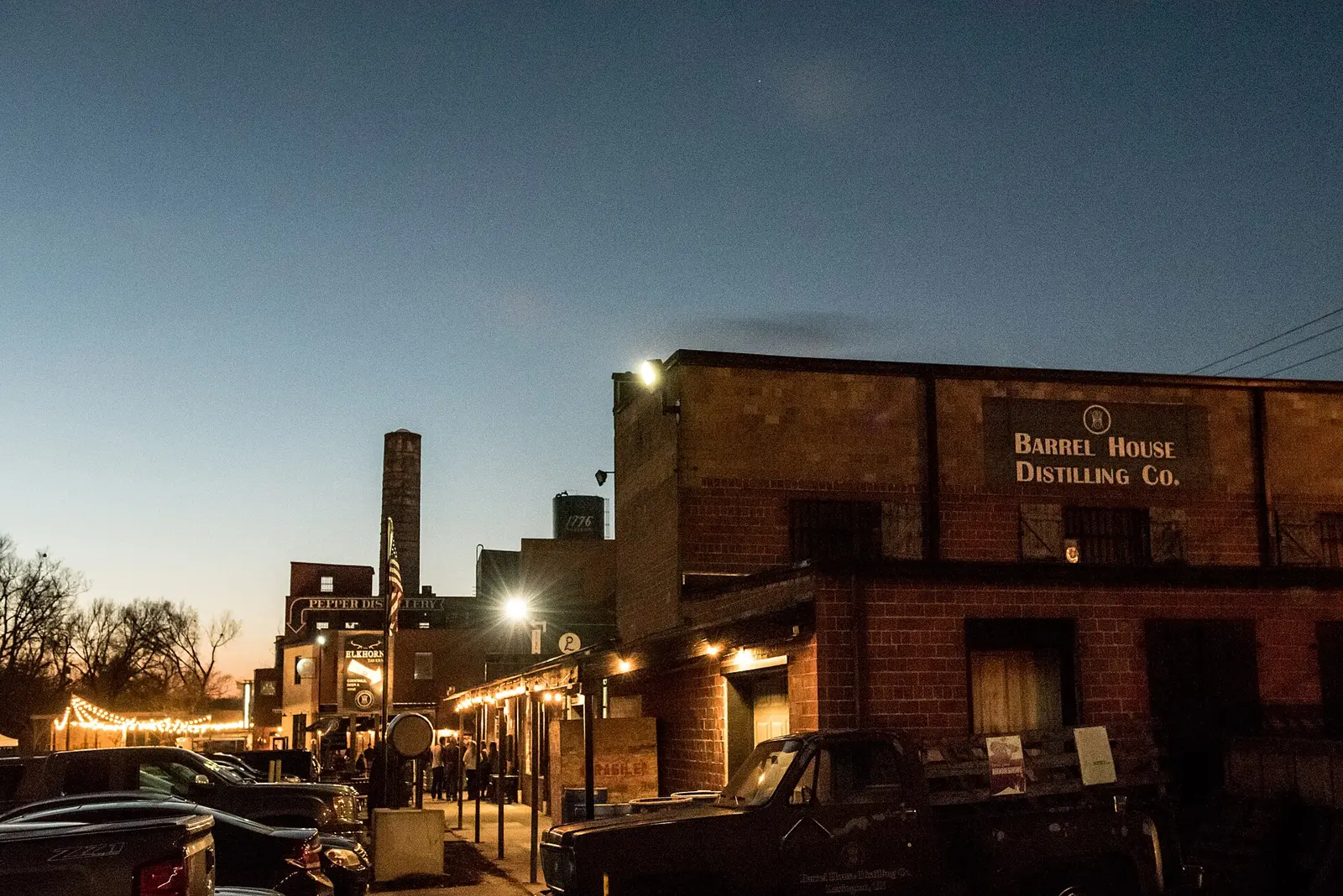Restaurants, bars and distilleries along the walkway in Lexington's Distillery District at dusk