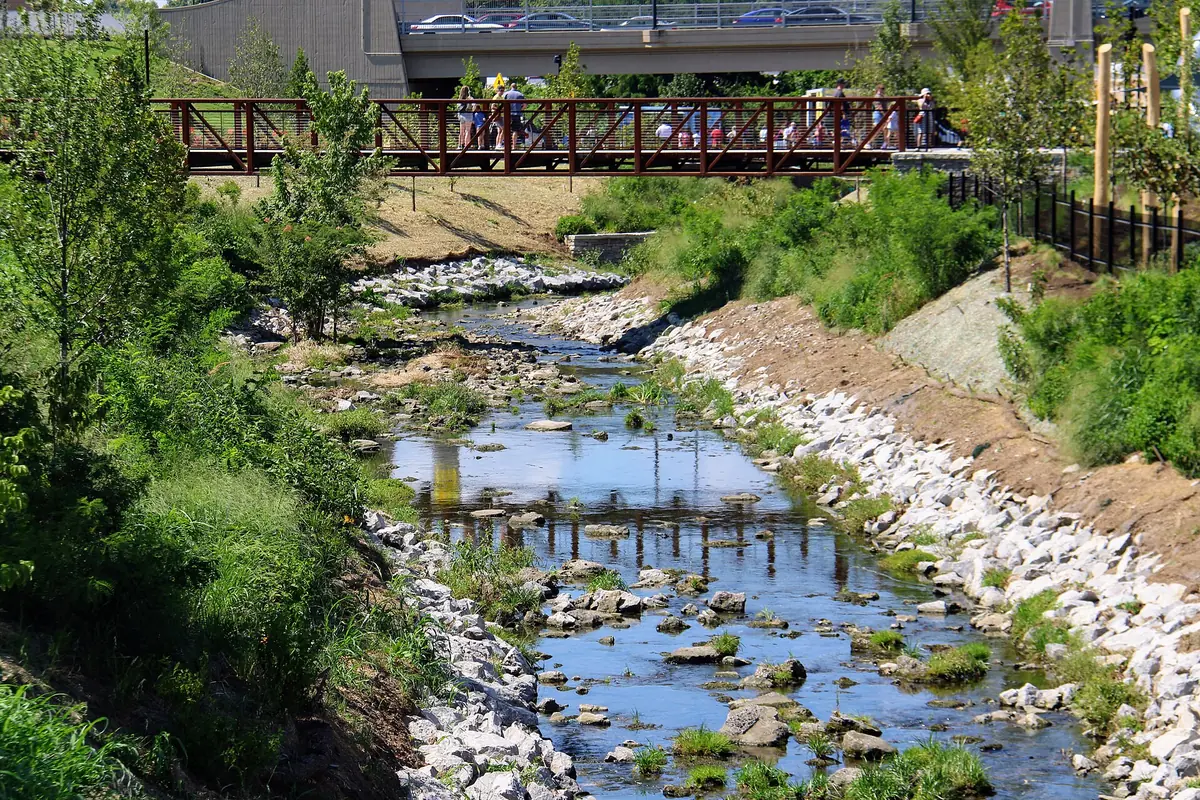 Walkers on a footbridge over Town Branch creek at Gatton Park on Town Branch in downtown Lexington